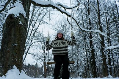Portrait of teenage girl standing on snow covered land