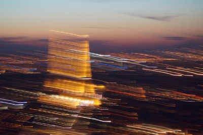 Aerial view of city lit up at night