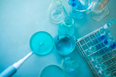 Close-up of laboratory glassware against blue background
