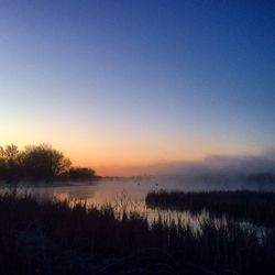 Scenic view of lake at sunset