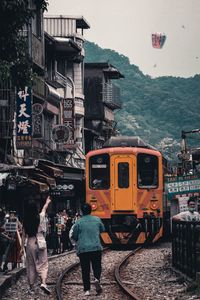 Train on railroad track in city