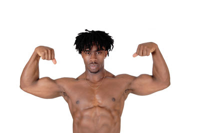 Portrait of young man standing against white background