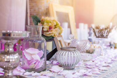 Close-up of flowers in glass on table