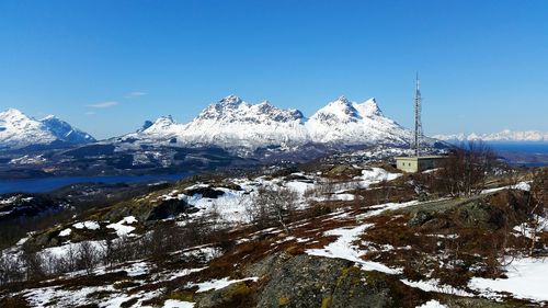 Snow covered mountain against blue sky