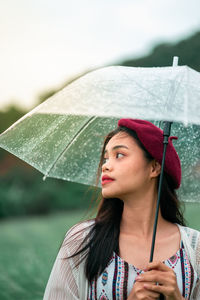 Portrait of a beautiful young woman in rain