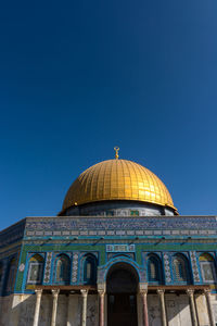 Low angle view of building against blue sky