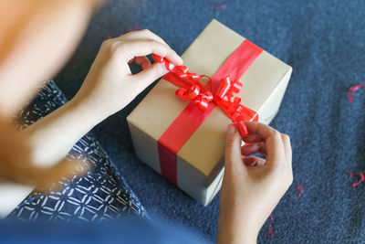 High angle view of woman holding red box