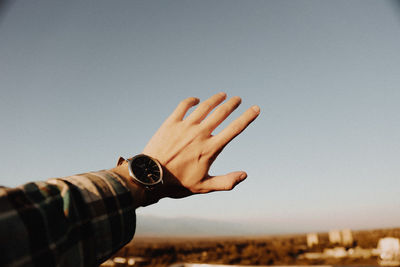 Midsection of person against clear sky