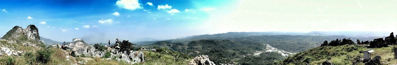 Panoramic view of mountains against cloudy sky