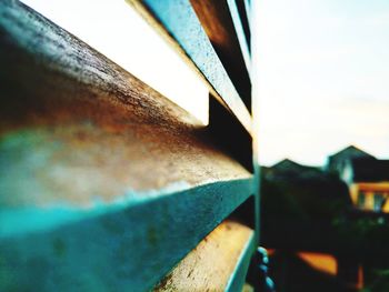 Close-up of rusty metal against building