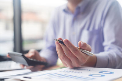 Young businessman working at desk in office