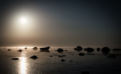 Scenic view of sea against sky at night