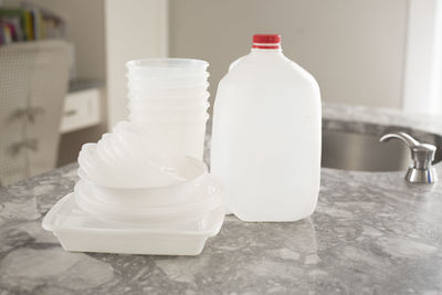 Close-up of white bottle on table at home