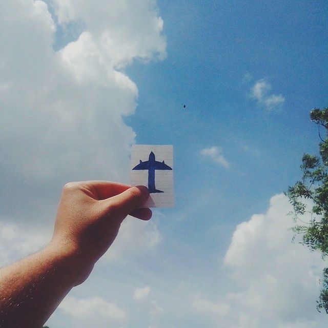 person, sky, part of, low angle view, holding, cloud - sky, cropped, human finger, cloud, unrecognizable person, personal perspective, cloudy, lifestyles, blue, leisure activity, outdoors, day