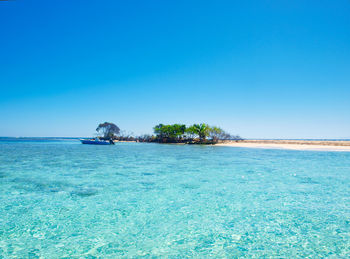 Scenic view of sea against clear blue sky