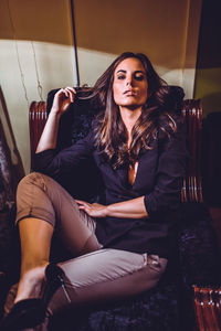 Portrait of young woman sitting at home