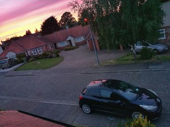 Car on road against buildings