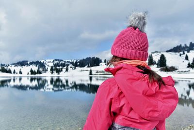 Rear view of woman in snow covered mountains