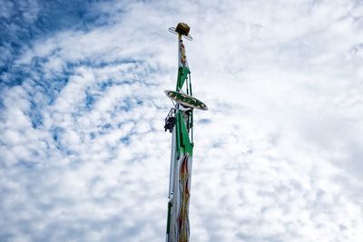 Low angle view of crane against sky