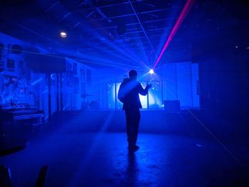 Man standing at illuminated nightclub