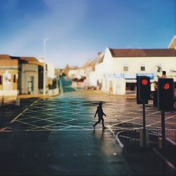 Man walking on street amidst buildings in city