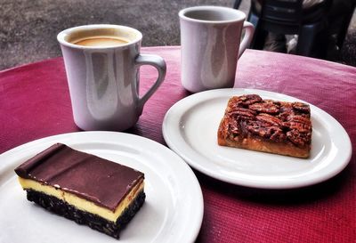 Dessert and coffee cups on table at sidewalk cafe