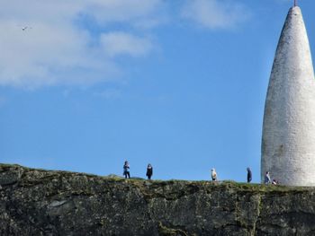 Tourist on rock edge close to tower