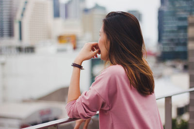 Midsection of woman standing in city