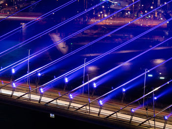 Illuminated light trails on bridge at night