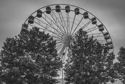 Low angle view of ferris wheel against sky