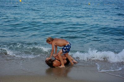 Two children play on the beach