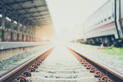 Surface level of railroad tracks against sky