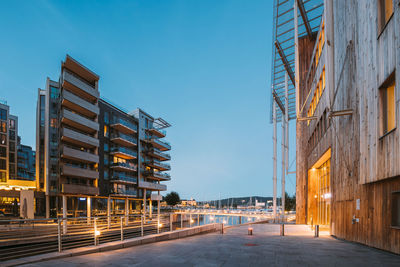 Illuminated buildings against clear sky