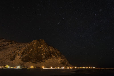 Scenic view of mountain against star field at night during winter