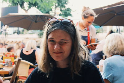 Portrait of someone sitting outdoors at a restaurant 