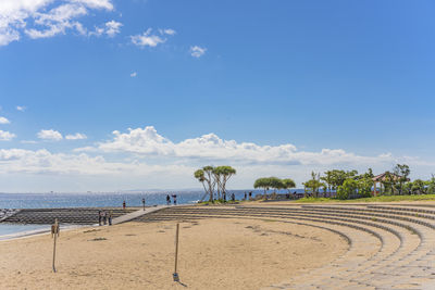 Beach umbrellas and palm trees on the sunset beach in chatan city in okinawa island in japan.