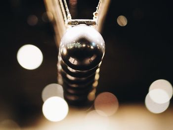 Close-up of illuminated lamp on table