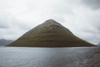 Scenic view of mountain against cloudy sky