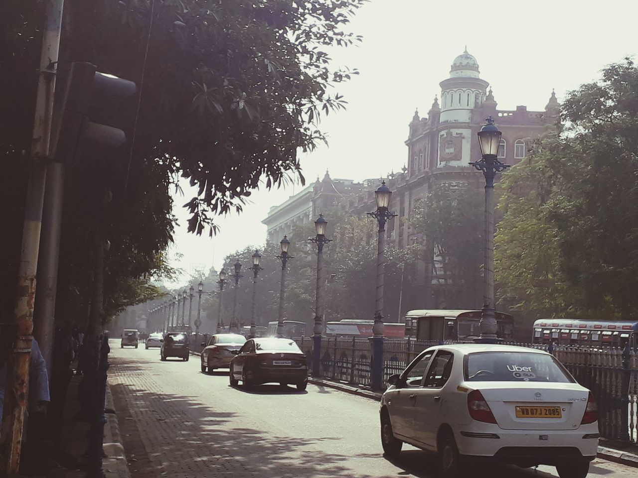 TRAFFIC ON CITY STREET AMIDST BUILDINGS