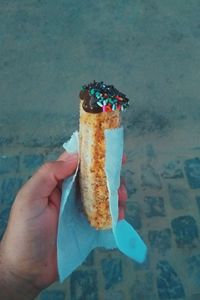 Close-up of hand holding ice cream cone