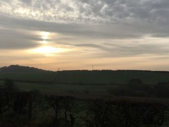 Scenic view of field against sky during sunset