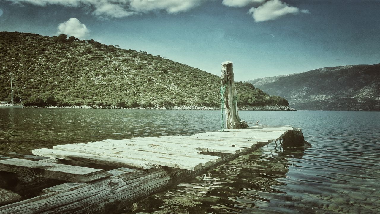 PIER ON LAKE AGAINST SKY