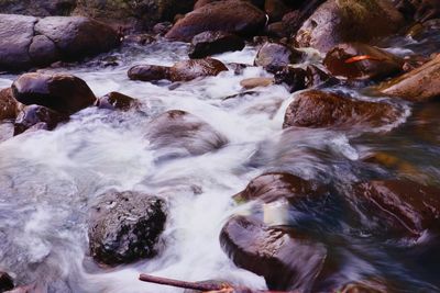 Stream flowing through rocks in sea