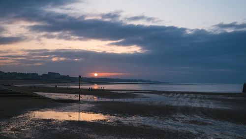 Scenic view of beach against sky during sunset