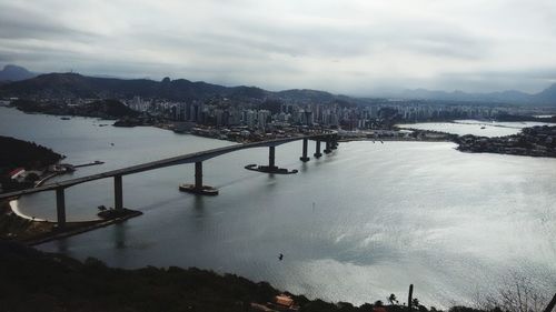 High angle view of city by sea against sky