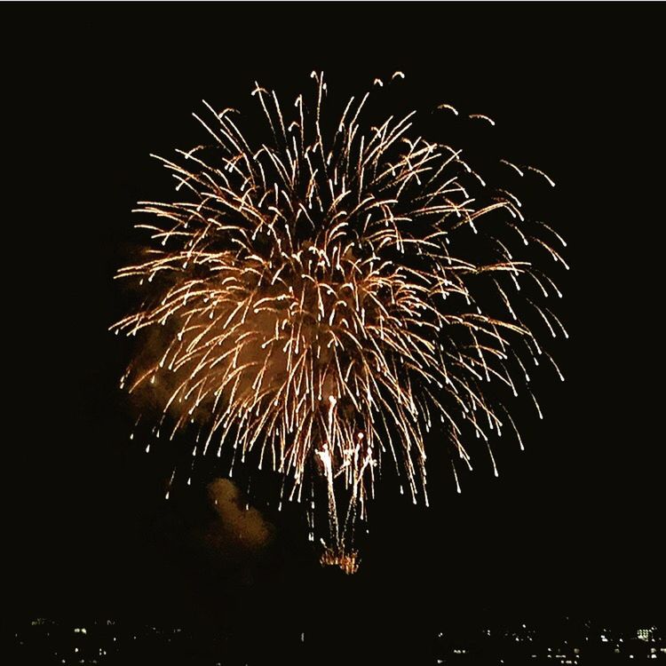 celebration, long exposure, night, motion, firework display, low angle view, exploding, arts culture and entertainment, glowing, firework - man made object, sky, event, sparks, illuminated, outdoors, entertainment