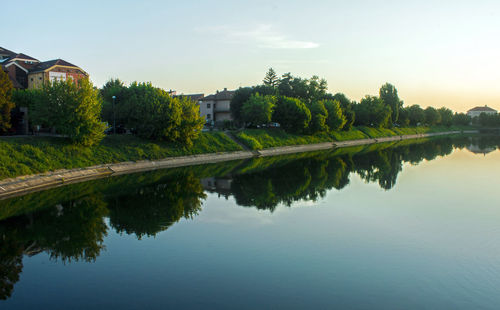 Scenic view of lake by building against sky