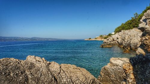 Scenic view of sea against clear blue sky