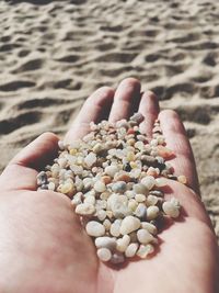 Close-up of person hand holding sand