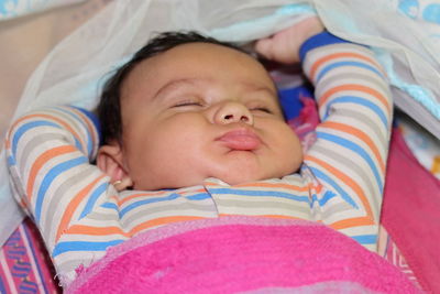 High angle view of baby sleeping on bed